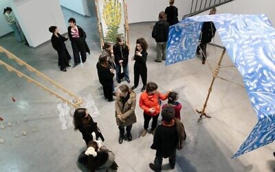 Visitors view artist Ester Schneider's 'Hoshana,' at Bat Yam Museum of Art through June 15, 2025 (Courtesy)
