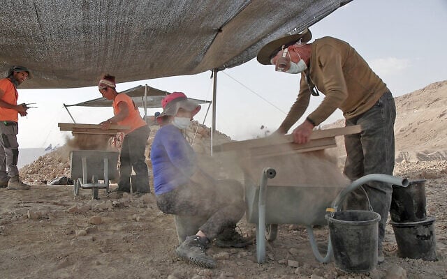 Archaeologists of the Israel Antiquities Authority excavating a 2,200-year-old site north of Nahal Zohar in the Judean Desert in March 2025. (Emil Aladjem/Israel Antiquities Authority)