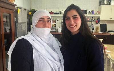 Malak Khizran, right, with her mother, Malika, at their home in the Druze village of Yarka, Western Galilee on March 4, 2025. (Diana Bletter/Times of Israel)