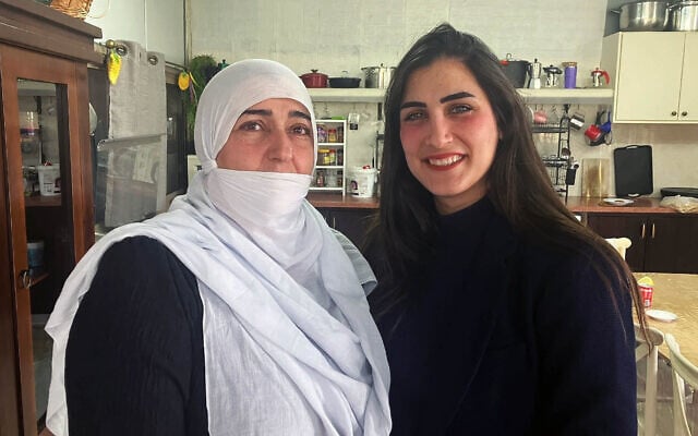 Malak Khizran, right, with her mother, Malika, at their home in the Druze village of Yarka, Western Galilee, adjacent to Julis, on March 4, 2025. (Diana Bletter/Times of Israel)