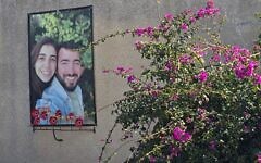 A poster memorializing Nirel Zini and Niv Raviv hangs outside the house where they lived in a neighborhood for young families at Kibbutz Kfar Aza, February 2025. (Bernard Dichek)