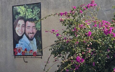 A poster memorializing Nirel Zini and Niv Raviv hangs outside the house where they lived in a neighborhood for young families at Kibbutz Kfar Aza, February 2025. (Bernard Dichek)