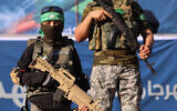 Illustrative: A Palestinian boy carries a toy gun while standing with members of Al-Qassam Brigades, the armed wing of the Hamas movement, during a rally in Gaza City on May 24, 2021. (AFP / Emmanuel DUNAND)