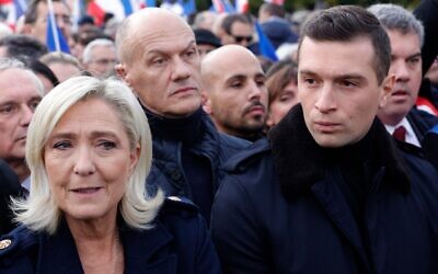 French far-right party Rassemblement National (RN) MP Marine Le Pen (L) and RN leader Jordan Bardella (R) march during a demonstration against antisemitism in Paris, on November 12, 2023. (Geoffroy Van der Hasselt/AFP)