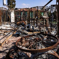 Charred objects are scattered on the ground, in Moshav Netiv Ha'asara in southern Israel near the border with the Gaza Strip  on November 17, 2023, in the aftermath of Hamas's October 7 terror onslaught. (RONALDO SCHEMIDT / AFP)