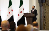 This handout picture released by the official Syrian Arab News Agency (SANA) shows Syria's interim president Ahmed al-Sharaa addressing representatives and dignitaries of Syrian communities during the National Dialogue Conference called for by the country's new authorities in Damascus on February 25, 2025.  (SANA/AFP)