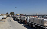 Trucks carrying humanitarian aid line up on the Egyptian side of the Rafah border crossing with the Gaza Strip on March 2, 2025 after Israel suspended the entry of supplies into the Palestinian enclave. (AFP)