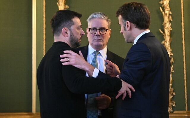 (L-R) Ukraine's President Volodymyr Zelensky, Britain's Prime Minister Keir Starmer and France's President Emmanuel Macron embrace after holding a meeting during a summit at Lancaster House in central London on March 2, 2025. (Justin Tallis / Pool / AFP)