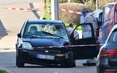 Forensic officers examine a damaged vehicle at the site of a car-ramming attack in Mannheim, southwestern Germany, March 3, 2025. (Thomas Lohnes / AFP)