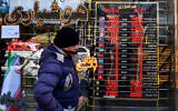 A man walks past a currency exchange shop in the Grand Bazaar in Tehran on March 3, 2025. (Atta KENARE / AFP)