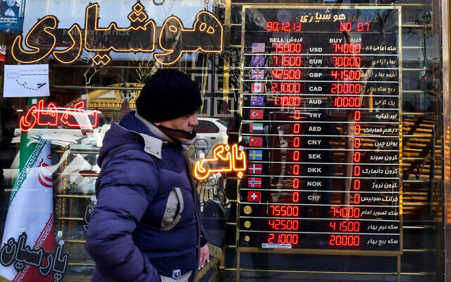 A man walks past a currency exchange shop in the Grand Bazaar in Tehran on March 3, 2025. (Atta KENARE / AFP) A man walks past a currency exchange shop in the Grand Bazaar in Tehran on March 3, 2025. (Atta KENARE / AFP)