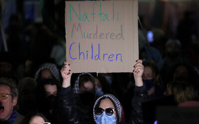 An anti-Israel protester holds up a sign outside the campus of Columbia University in New York City on March 4, 2025, to protest a speech by former prime minister Naftali Bennett (CHARLY TRIBALLEAU / AFP)