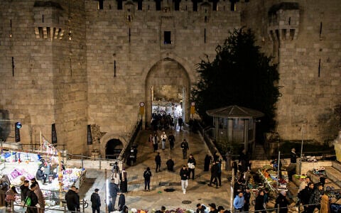 People walk through Damascus gate into the old city of Jerusalem on March 6, 2025, during the Muslim holy fasting month of Ramadan. (John Wessels/AFP)