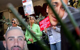 Demonstrators raise cutout portraits of Israeli hostages during a protest calling for the implementation of the second phase and the completion of the agreement for the release of all hostages, in Tel Aviv on March 6, 2025. (Jack GUEZ / AFP)