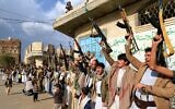 Armed Yemenis shout slogans and raise their weapons during a protest against Israel's decision to halt the flow of aid into the Gaza Strip, in Yemen's Houthi-controlled capital of Sanaa, March 11, 2025. (Mohammed Huwais / AFP)