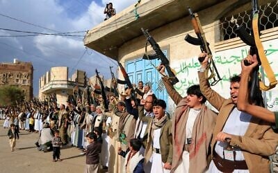 Armed Yemenis shout slogans and raise their weapons during a protest against Israel's decision to halt the flow of aid into the Gaza Strip, in Yemen's Houthi-controlled capital of Sanaa, March 11, 2025. (Mohammed Huwais / AFP)