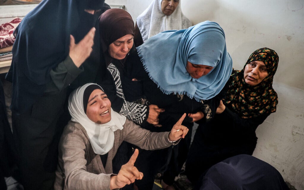 Women mourn during the funeral  for a person killed in an Israeli strike in Bureij in the Gaza Strip on March 11, 2025. (Photo by Eyad BABA / AFP)