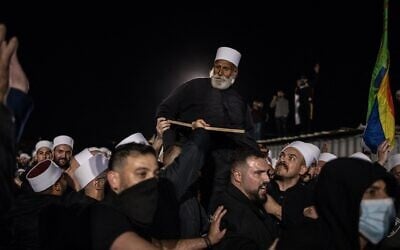 People carry a Syrian Druze cleric at the tomb of Nabi Shuaib in northern Israel on March 14, 2025. (John Wessels/AFP)