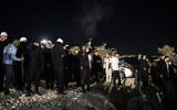 A man fires a weapon in the air ahead of the arrival of Syrian Druze clerics at the tomb of Nabi Shuaib in northern Israel on March 14, 2025. There is no suggestion the man depicted caused the injury of a woman (John Wessels / AFP)