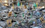 Pictures of Hassan Nasrallah, the slain former leader of Lebanese Shiite terror group Hezbollah, and other killed fighters are displayed amid the rubble of destroyed buildings as people prepare a mass fast-breaking iftar meal in Lebanon's southern village of Khiam, near the border with Israel on March 15, 2025. (Photo by Rabih DAHER / AFP)