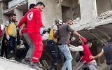 Syrian Civil Defense and first responders rescue a victim from the site of an explosion in Syria's western coastal city of Latakia, March 15, 2025. (Sana / AFP)