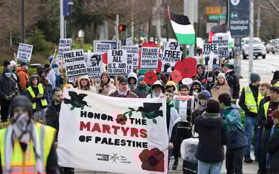 People hold signs as they protest the arrest of former Columbia University anti-Israel student activist Mahmoud Khalil during a 'Fight for Our Rights' demonstration at the University of Washington campus in Seattle, Washington, March 15, 2025. (Jason Redmond / AFP)