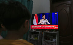 Yemenis in Sanaa watch a televised statement by the Houthi military spokesman Yahya Saree announcing the rebel group launched an attack on a US aircraft carrier in the Red Sea on March 16, 2025. (Photo by Mohammed HUWAIS / AFP)
