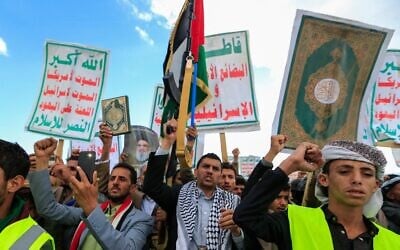 Supporters of Yemen's Iran-backed Houthi rebels brandish rifles and chant during a demonstration against US airstrikes, in Sanaa, Yemen, March 17, 2025. (Mohammed Huwais / AFP)