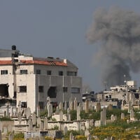Smoke billows behind a cemetery during Israeli strikes near Gaza City on March 18, 2025. (Omar AL-QATTAA / AFP)