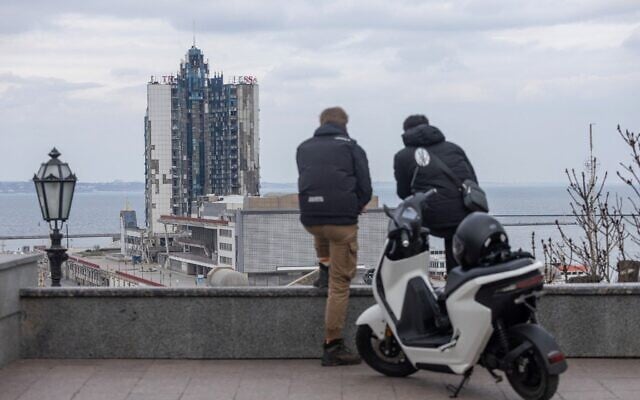 Two man stand looking towards the damaged nineteen-story hotel "Odessa," in the port city of Odessa, on the Black Sea in southern Ukraine on March 19, 2025. (Oleksandr GIMANOV / AFP) Two man stand looking towards the damaged nineteen-story hotel "Odessa," in the port city of Odessa, on the Black Sea in southern Ukraine on March 19, 2025. (Oleksandr GIMANOV / AFP)