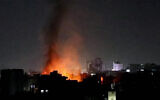 This image grab from an AFPTV footage shows smoke plumes rising above buildings following bombardment on Yemen's Houthi-controlled capital Sanaa on March 19, 2025. (AFP)
