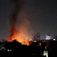 This image grab from an AFPTV footage shows smoke plumes rising above buildings following bombardment on Yemen's Houthi-controlled capital Sanaa on March 19, 2025. (AFP)