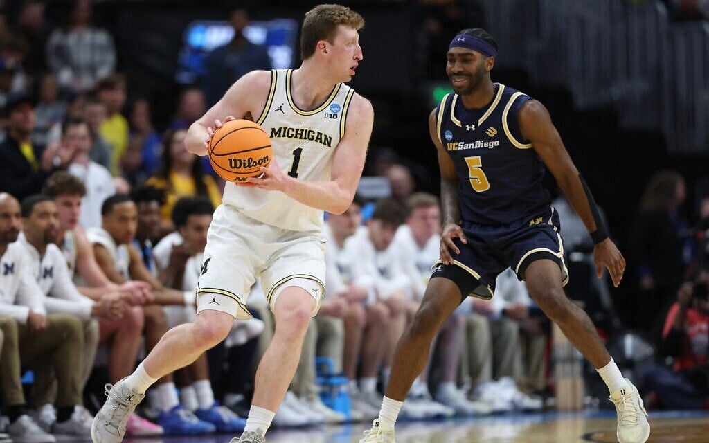 Danny Wolf #1 of the Michigan Wolverines drives against Justin Rochelin #5 of the UC San Diego Tritons during the second half in the first round of the NCAA Men's Basketball Tournament at Ball Arena on March 20, 2025 in Denver, Colorado. (Matthew Stockman/Getty Images/AFP) Danny Wolf #1 of the Michigan Wolverines drives against Justin Rochelin #5 of the UC San Diego Tritons during the second half in the first round of the NCAA Men's Basketball Tournament at Ball Arena on March 20, 2025 in Denver, Colorado. (Matthew Stockman/Getty Images/AFP)