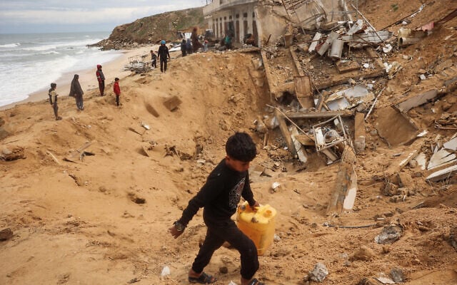 Palestinians inspect the rubble following an Israeli strike on a fishing harbor in Deir el-Balah in the central Gaza Strip, March 22, 2025. (Eyad Baba/AFP) Palestinians inspect the rubble following an Israeli strike on a fishing harbor in Deir el-Balah in the central Gaza Strip, March 22, 2025. (Eyad Baba/AFP)