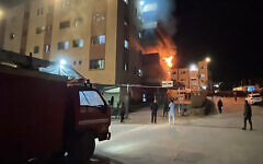 Palestinians try to put out a fire at the emergency department of the Nasser hospital after it was hit in an Israeli airstrike, in Khan Younis in the southern Gaza Strip on March 23, 2025. (AFP)