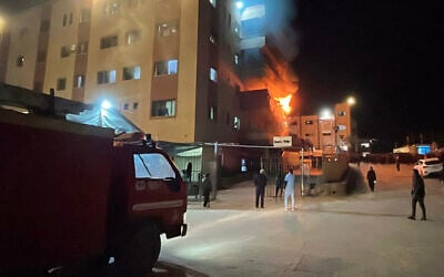 Palestinians try to put out a fire at the emergency department of the Nasser hospital after it was hit in an Israeli airstrike, in Khan Younis in the southern Gaza Strip on March 23, 2025. (AFP)