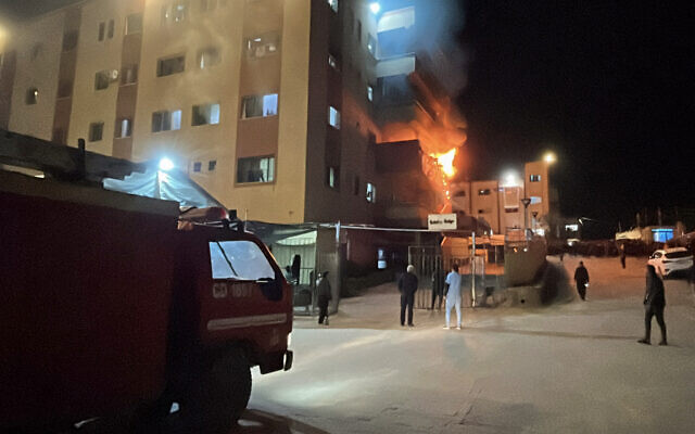 Palestinians try to put out a fire at the emergency department of the Nasser hospital after it was hit in an Israeli airstrike, in Khan Younis in the southern Gaza Strip on March 23, 2025. (AFP)