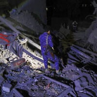 A fighter inspects the damage at a site of a reported US strike in Houthi-held Sanaa, Yemen late on March 23, 2025.  (Mohammed HUWAIS / AFP)