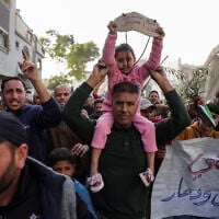 A slogan in Arabic reading (R): 'Enough killing and destruction' and another reading (L): 'The children of Palestine: We want to live' are displayed during a rally calling for an end to the war where hundreds chanted anti-Hamas slogans, in Beit Lahia, in the northern Gaza Strip, on March 25, 2025. (AFP)