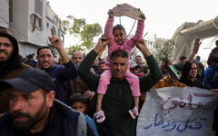 A slogan in Arabic reading (R): 'Enough killing and destruction' and another reading (L): 'The children of Palestine: We want to live' are displayed during a rally calling for an end to the war where hundreds chanted anti-Hamas slogans, in Beit Lahia, in the northern Gaza Strip, on March 25, 2025. (AFP)