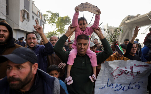 A slogan in Arabic reading (R): 'Enough killing and destruction' and another reading (L): 'The children of Palestine: We want to live' are displayed during a rally calling for an end to the war where hundreds chanted anti-Hamas slogans, in Beit Lahia, in the northern Gaza Strip, on March 25, 2025. (AFP)