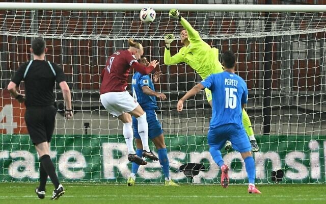 Israeli goalie Daniel Peretz saves an attempt on goal during the 2026 World Cup Group I qualifier soccer match between Israel and Norway, in Debrecen, Hungary, on March 25, 2025. (Attila Kisbenedek/AFP) Israeli goalie Daniel Peretz saves an attempt on goal during the 2026 World Cup Group I qualifier soccer match between Israel and Norway, in Debrecen, Hungary, on March 25, 2025. (Attila Kisbenedek/AFP)