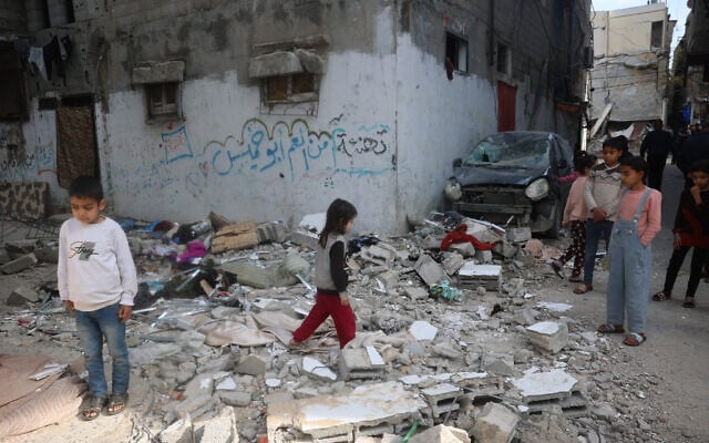 Palestinian children stand on rubble after an earlier Israeli strike hit an apartment in the Bureij refugee camp in the central Gaza Strip on March 26, 2025. (Photo by Eyad BABA / AFP) Palestinian children stand on rubble after an earlier Israeli strike hit an apartment in the Bureij refugee camp in the central Gaza Strip on March 26, 2025. (Photo by Eyad BABA / AFP)