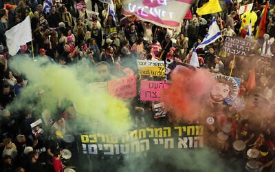 Demonstrators raise placards and light flares during an anti-government protest calling for action to secure the release of Israeli hostages, Tel Aviv on March 29, 2025. (Jack GUEZ / AFP)