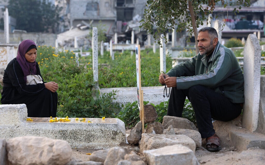 Palestinians visit the grave of a relative after Eid al-Fitr prayers, which marks the end of the holy fasting month of Ramadan, in Gaza City on March 30, 2025. (Omar Al-Qattaa/AFP)