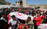 Members of the Palestine Red Crescent and other emergency services carry bodies of fellow rescuers killed a week earlier by Israeli forces, during a funeral procession at Nasser hospital in Khan Younis in the southern Gaza Strip on March 31, 2025. (Eyad BABA / AFP)