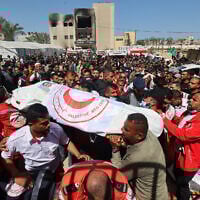Members of the Palestine Red Crescent and other emergency services carry bodies of fellow rescuers killed a week earlier by Israeli forces, during a funeral procession at Nasser hospital in Khan Younis in the southern Gaza Strip on March 31, 2025. (Eyad BABA / AFP)