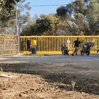 Palestinian terrorists are seen at an entrance to Kibbutz Nir Oz, during the Hamas-led onslaught on October 7, 2023. (AP/Hassan Eslaiah)
