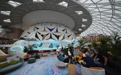 People lounge in the AquaDome area of Icon of the Seas, the world's largest cruise ship, during a media day preview as it prepares for its inaugural public voyage, January 11, 2024, in Miami. (AP/Rebecca Blackwell)