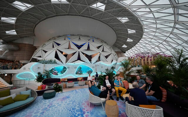 People lounge in the AquaDome area of Icon of the Seas, the world's largest cruise ship, during a media day preview as it prepares for its inaugural public voyage, January 11, 2024, in Miami. (AP/Rebecca Blackwell)